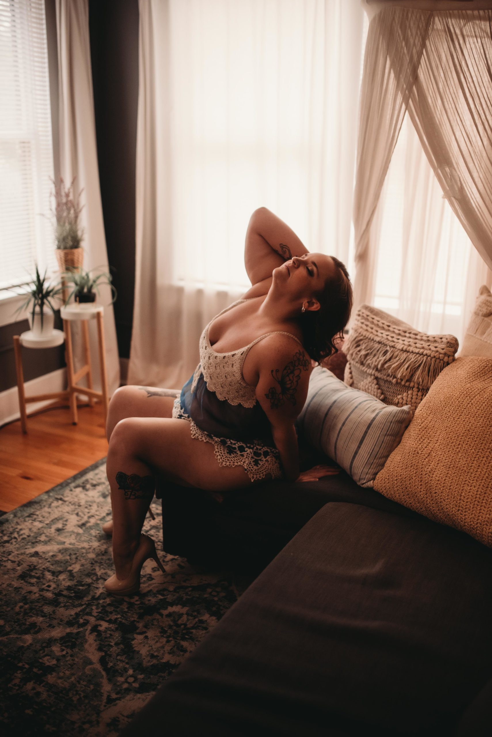 a woman celebrating her weight loss journey in a boudoir session